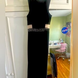 Cocktail dress has beautiful see through waistline in both sides